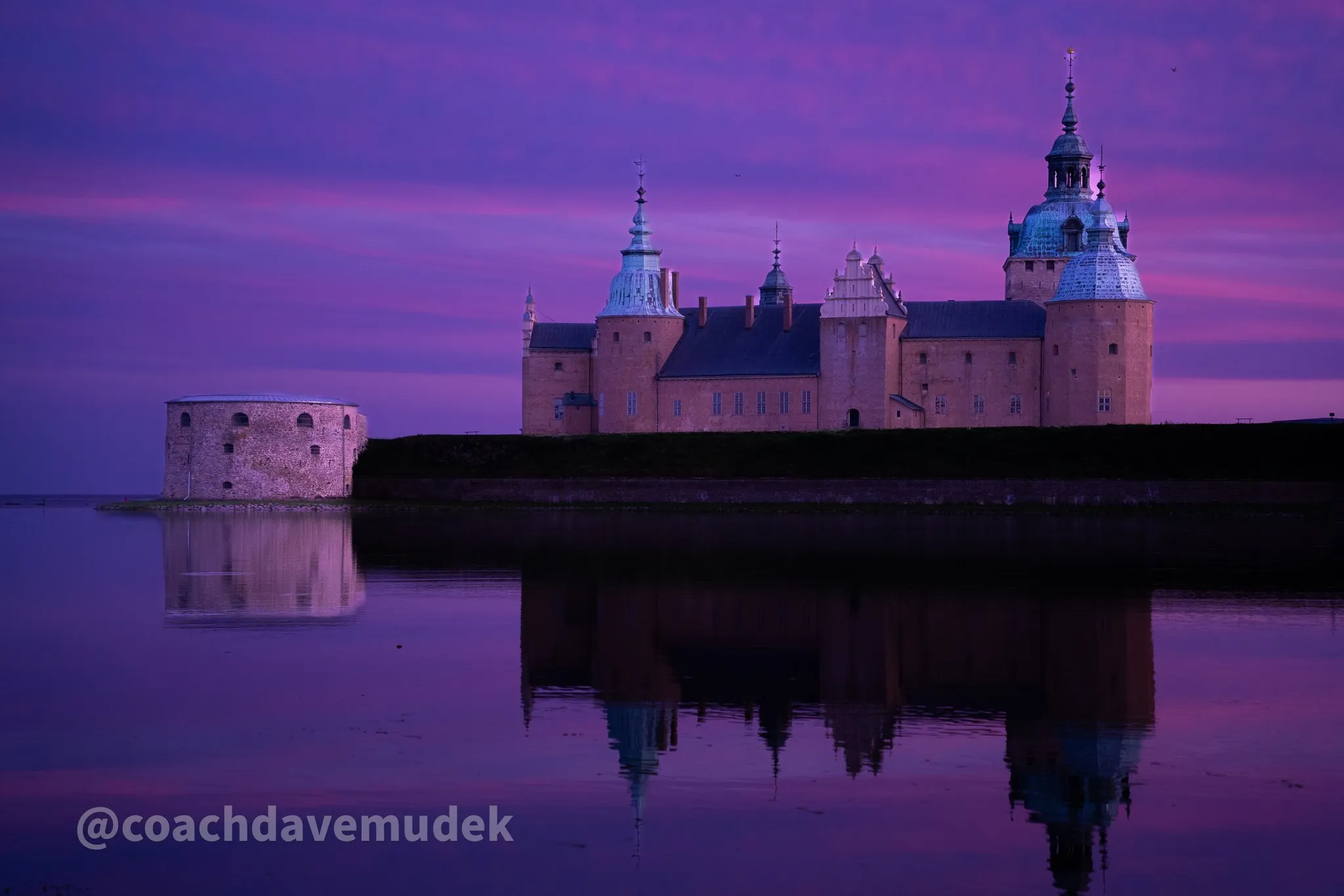 Kalmar Castle in Sweden at sunset, reflected in still water
